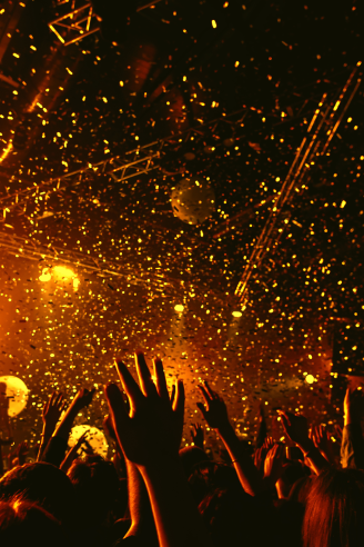 people raising their hands at an event