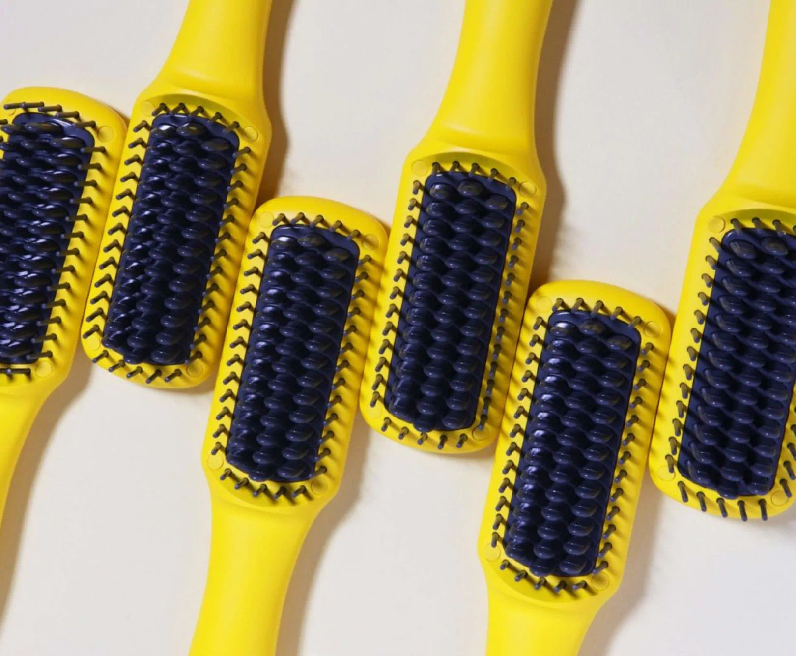 A row of blue and yellow brushes.